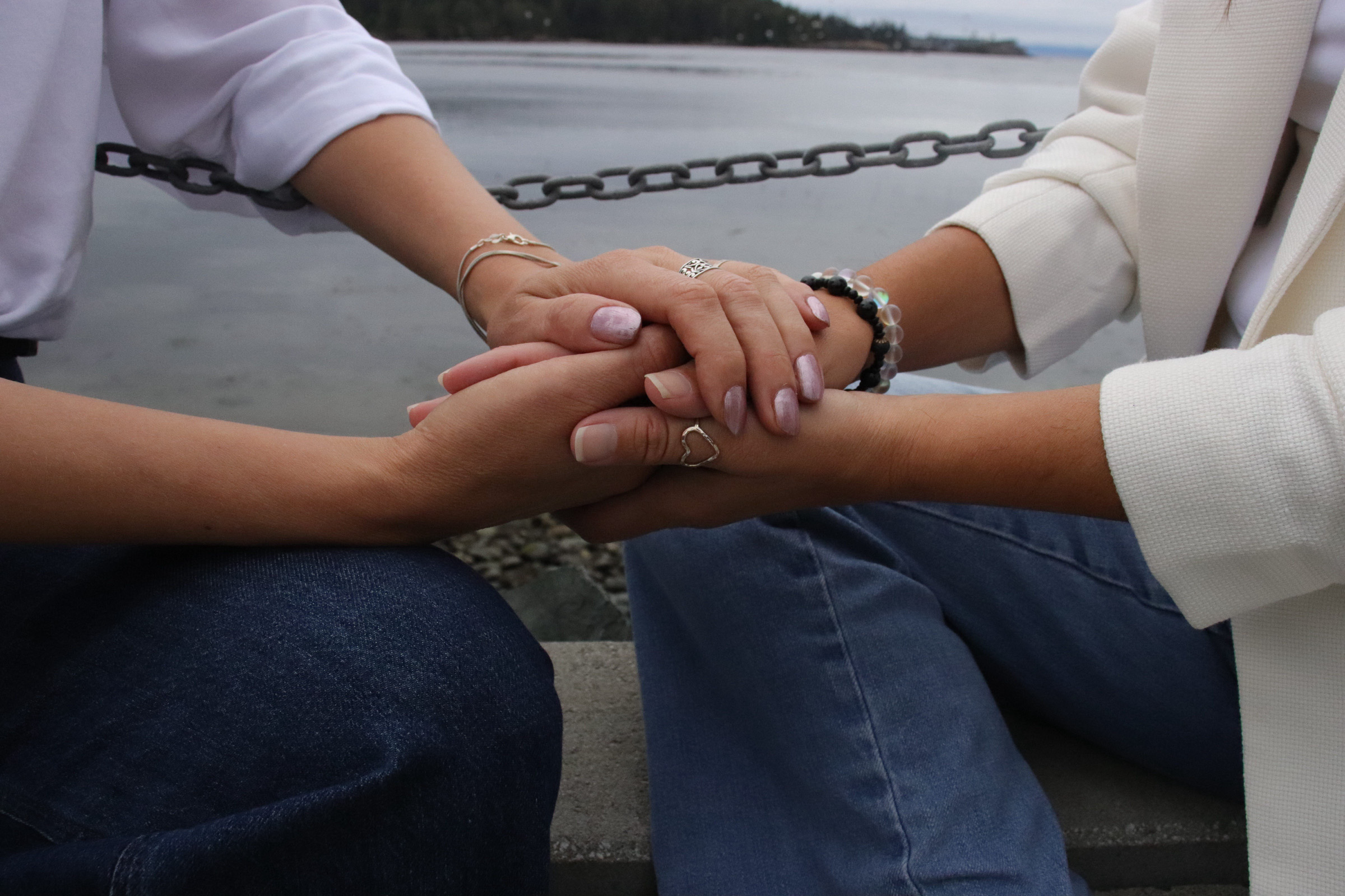 Two people holding hands in conversation