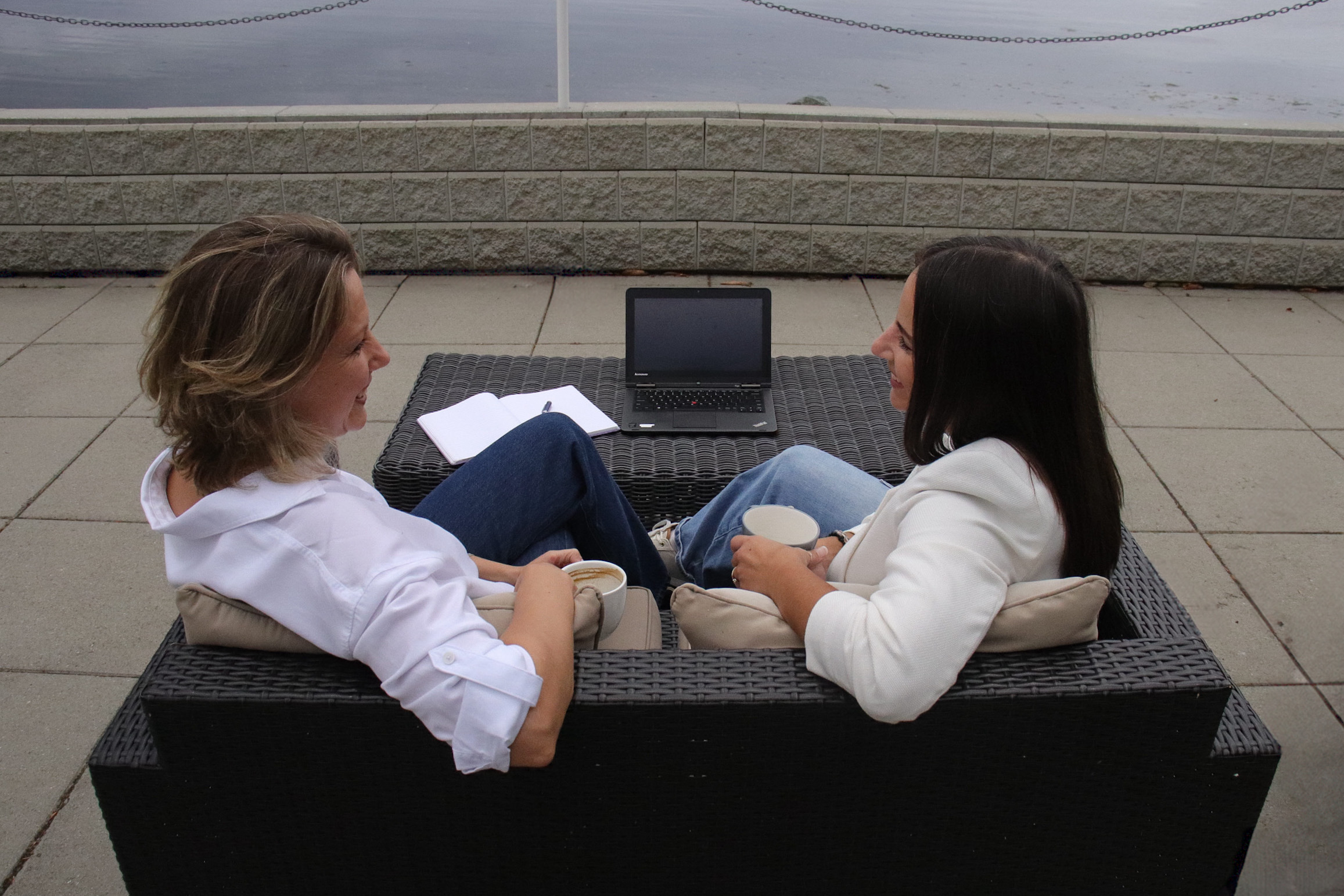 Ekaterina Thomas in conversation with a client overlooking the water